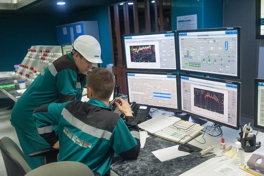 Technicians monitoring system dashboards