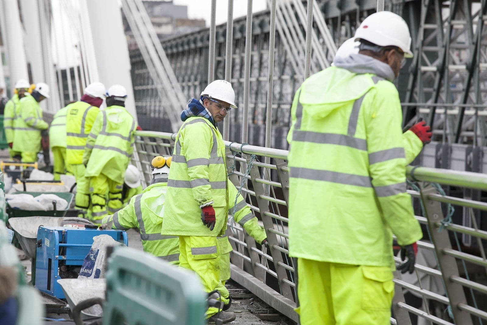 Construction site team in safety vests and hard hats