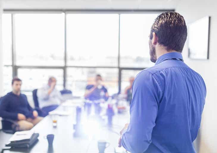 Tutor leading ISO training in a modern meeting room